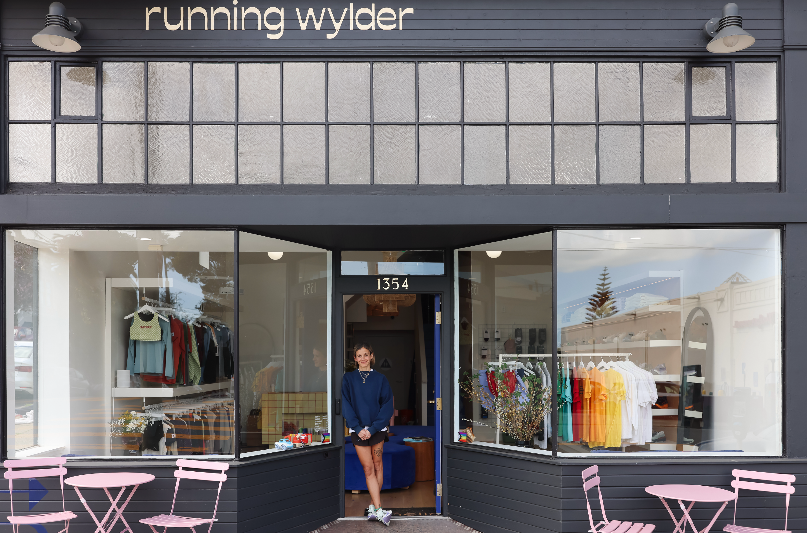 Exterior of the Running Wylder store at 1354 Castro Street with window displays of colorful apparel and pink bistro seating out front
